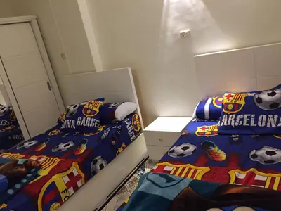 a bedroom with two beds with soccer themed sheets at Babylon guesthouse in Aswan