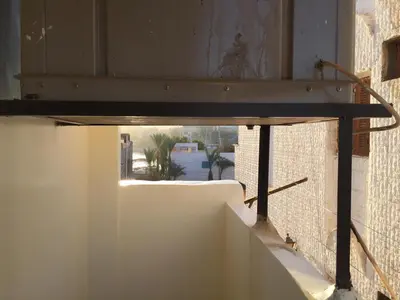 a wooden table in a room with a window at Babylon guesthouse in Aswan