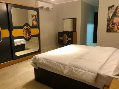 a bedroom with a large bed and a mirror at Villa KUBA luxury private pool 2 in Hurghada