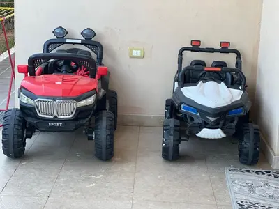 two golf carts are parked next to a wall at Villa KUBA luxury private pool 2 in Hurghada