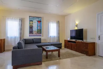 a living room with a couch and a flat screen tv at El Gouna abo tig marina 1 bedroom apartment and 1 bedroom at the Roof in Hurghada