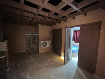an empty room with a television and a room with a microwave at El Gouna abo tig marina 1 bedroom apartment and 1 bedroom at the Roof in Hurghada