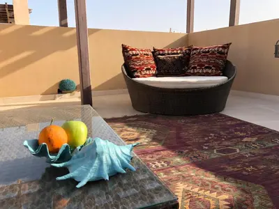 a living room with a couch and fruit on a table at El Gouna abo tig marina 1 bedroom apartment and 1 bedroom at the Roof in Hurghada