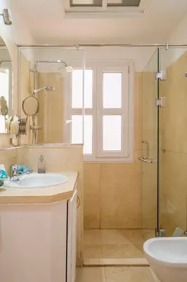a bathroom with a sink and a glass shower at El Gouna abo tig marina 1 bedroom apartment and 1 bedroom at the Roof in Hurghada
