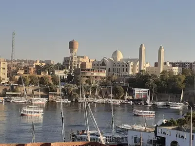 a group of boats are docked in a harbor at Nubia castle in Aswan