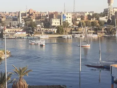 a view of a river with boats in a city at Nubia castle in Aswan