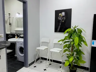 a bathroom with a sink and a washing machine at Lima Modern. Sea View. Strong Wi Fi. Sheraton Road in Hurghada