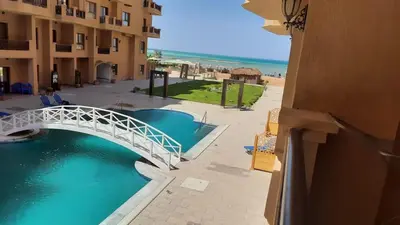 a white bridge over a body of water next to a building at Tertels beach resort hurghada F 2-6 in Hurghada