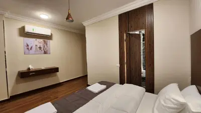 a bedroom with a white bed in a room at Sphinx Luxor Apartment in Luxor