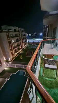 a balcony with a table and chairs and a pool at Sphinx Luxor Apartment in Luxor
