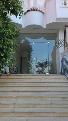 a building with stairs in front of a glass door at Marvel flat in Hurghada