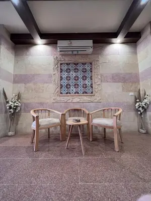 a room with two chairs and a table and a window at Boho Homes in Hurghada