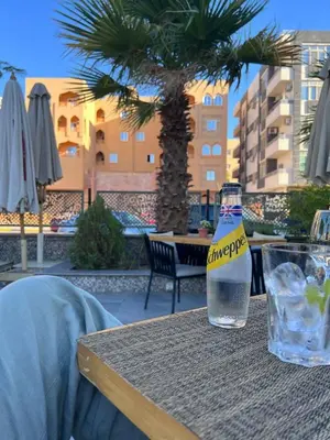 a bottle of water sitting on top of a table at Boho Homes in Hurghada