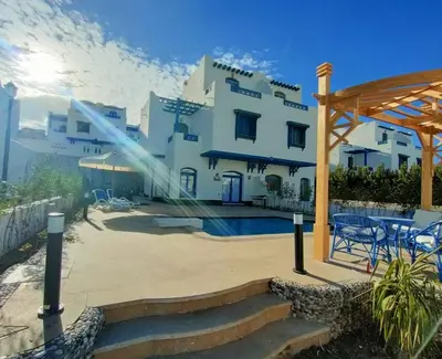 a large white building with a gazebo at Amaros Sahl Hasheesh sea view Villa with Pool سهل حشيش in Hurghada
