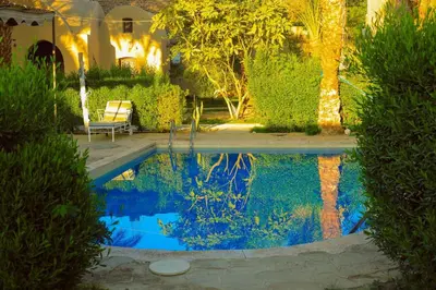 a swimming pool in the middle of a yard at Sekhmet Retreat Centre in Luxor