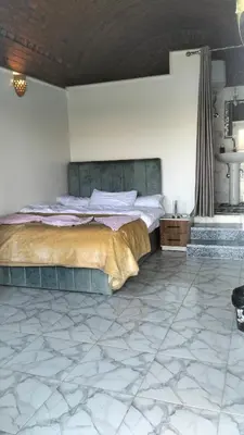 a bedroom with a bed in a room with marble floors at Go Inn Backpackers in Aswan