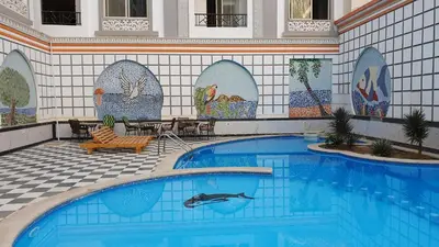 a swimming pool with a dolphin in the middle at 304 الشيراتون بلازا in Hurghada