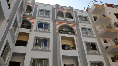 a tall white building with balconies and windows at 304 الشيراتون بلازا in Hurghada