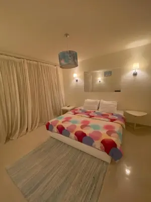 a bedroom with a bed with a colorful comforter at A studio in Veranda Sahl Hasheesh in Hurghada