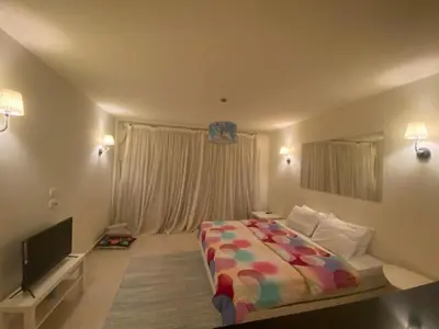 a bedroom with a bed and a flat screen tv at A studio in Veranda Sahl Hasheesh in Hurghada