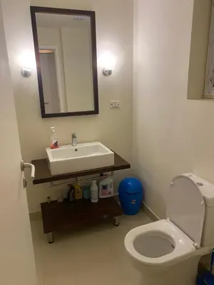 a bathroom with a sink and a toilet and a mirror at A studio in Veranda Sahl Hasheesh in Hurghada