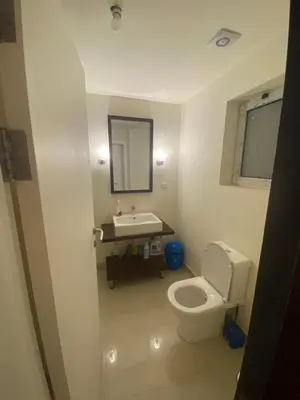 a bathroom with a white toilet and a sink at A studio in Veranda Sahl Hasheesh in Hurghada