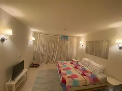 a bedroom with a bed and a flat screen tv at A studio in Veranda Sahl Hasheesh in Hurghada