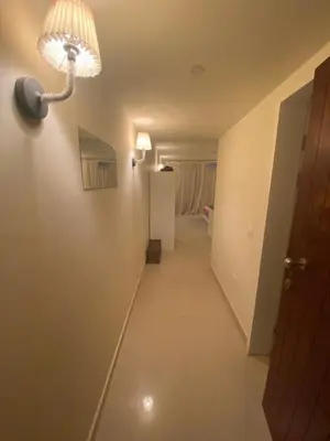 a long hallway with a light on the wall and a room at A studio in Veranda Sahl Hasheesh in Hurghada