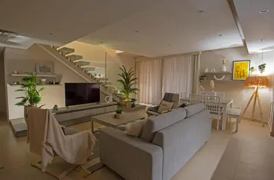 a living room with a couch and a tv at A Stunning Seaview Penthouse; 3bedrooms + nanny in Hurghada