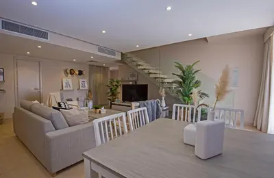 a living room with a couch and a dining room at A Stunning Seaview Penthouse; 3bedrooms + nanny in Hurghada
