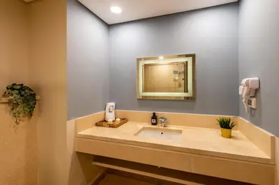 a bathroom with a sink and a mirror at Balanced & Bright 2 BDR Mangroovy Free Pool & Beach Access in Hurghada