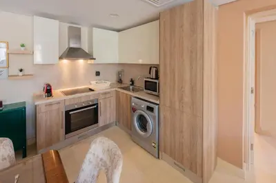 a kitchen with a washer and dryer at Balanced & Bright 2 BDR Mangroovy Free Pool & Beach Access in Hurghada