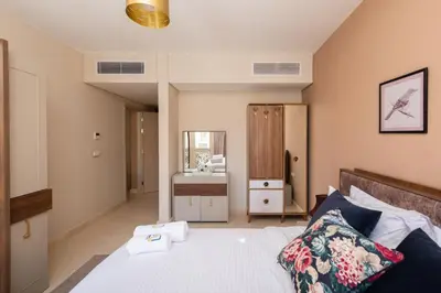 a bedroom with a bed and a mirror at Balanced & Bright 2 BDR Mangroovy Free Pool & Beach Access in Hurghada