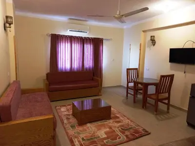 a living room with a couch and a table at Embrace Guest House in Luxor