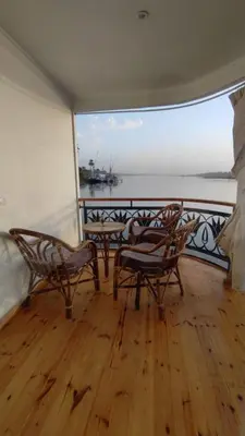 a balcony with chairs and a view of the ocean at Embrace 1 Nile Sailing Dahabiya in Luxor