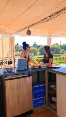 two women standing at a counter in a food truck at Embrace 1 Nile Sailing Dahabiya in Luxor