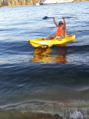 a person in a yellow kayak on the water at Embrace 1 Nile Sailing Dahabiya in Luxor
