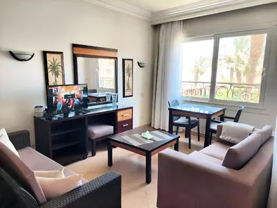 a living room with a desk and a table at JWE Residence - Quality experience near Red Sea in Hurghada