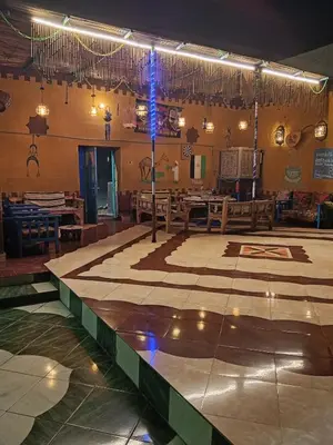 a large room with a stage with tables and lights at Miral Nubian House in Aswan
