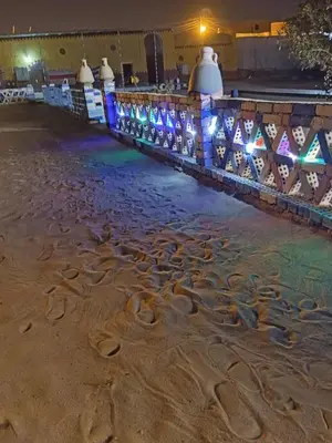 a pool of water at night with lights at Miral Nubian House in Aswan