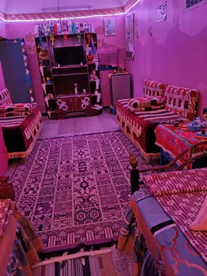 a purple room with beds and a stage in it at Miral Nubian House in Aswan