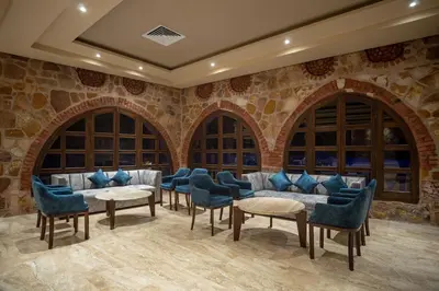 a waiting room with blue chairs and couches at Utopia Beach Club in Marsa Alam City