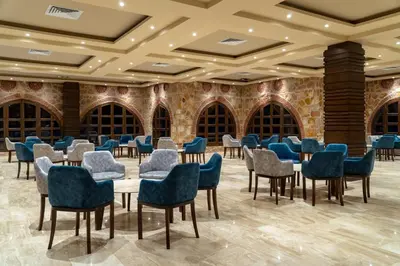 a large room with tables and chairs in a library at Utopia Beach Club in Marsa Alam City