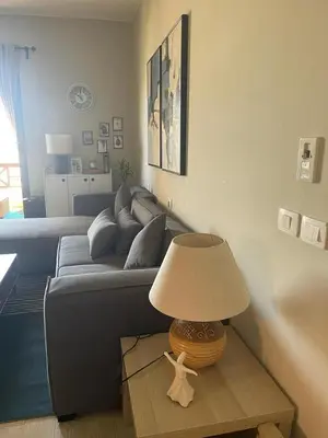 a living room with a couch and a table with a lamp at Babel Apartments Hotel El Gouna in Hurghada