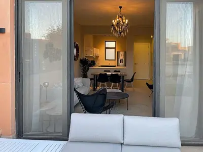a living room with a couch and a dining room at Babel Apartments Hotel El Gouna in Hurghada