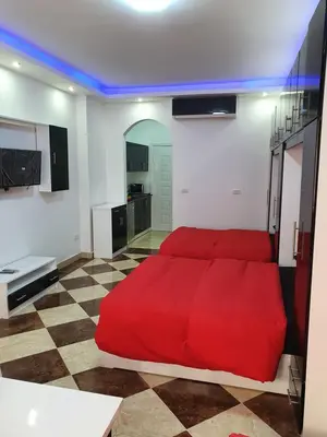a bedroom with a red bed in a room at sheraton blaza307 in Hurghada