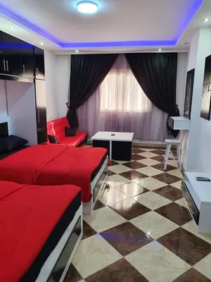 a hotel room with two beds and a table at sheraton blaza307 in Hurghada