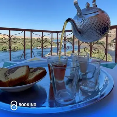 a tray with a plate of bread and a tea kettle at Belle Vue Sur Le Nile بيت هاني in Aswan