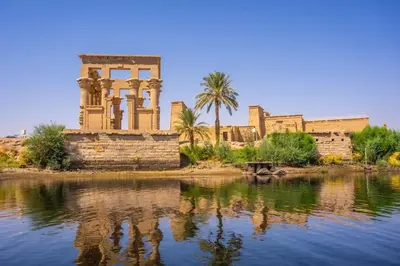 an ancient building next to a body of water at Belle Vue Sur Le Nile بيت هاني in Aswan