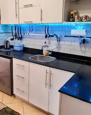 a kitchen with a sink and a counter top at Florenza Blue Sky & Poolview Studio Hurghada in Hurghada